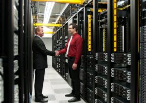 Two people shaking hands in a data center as they sign a partnership deal for multi cloud direct connect